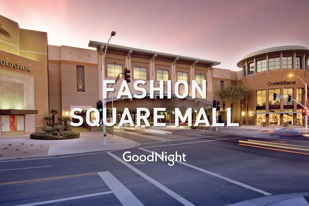 The image captures the entrance to Scottsdale Fashion Square, with recognizable storefronts like Nordstrom and Crate & Barrel, shaded by palm trees. The atmosphere is energetic and family-friendly, inviting visitors to shop and dine together.