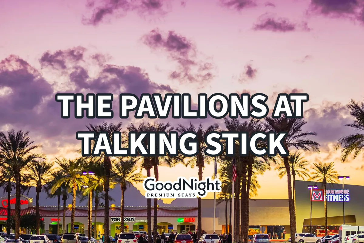 A lively exterior streetscape with palm trees, boutique storefronts, and a sunset sky. The area is bustling, suggesting a vibrant neighborhood filled with dining, shopping, and social opportunities within walking distance.