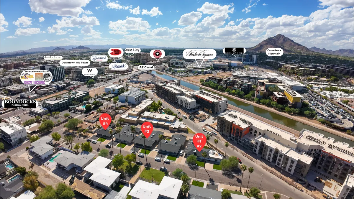 An exterior view capturing the property’s four distinct units alongside the vibrant Arizona Canal, with visible Camelback Mountain and Downtown Old Town in the background. The scene is energetic, showing proximity to local attractions and walkable amenities.